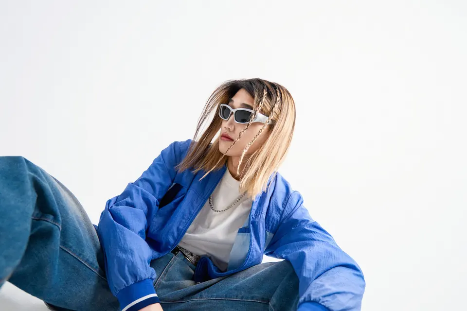 P3PPER sitting in a blue jacket
