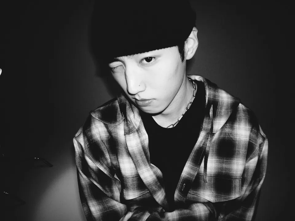 A black-and-white photo of MAR VISTA in a plaid shirt